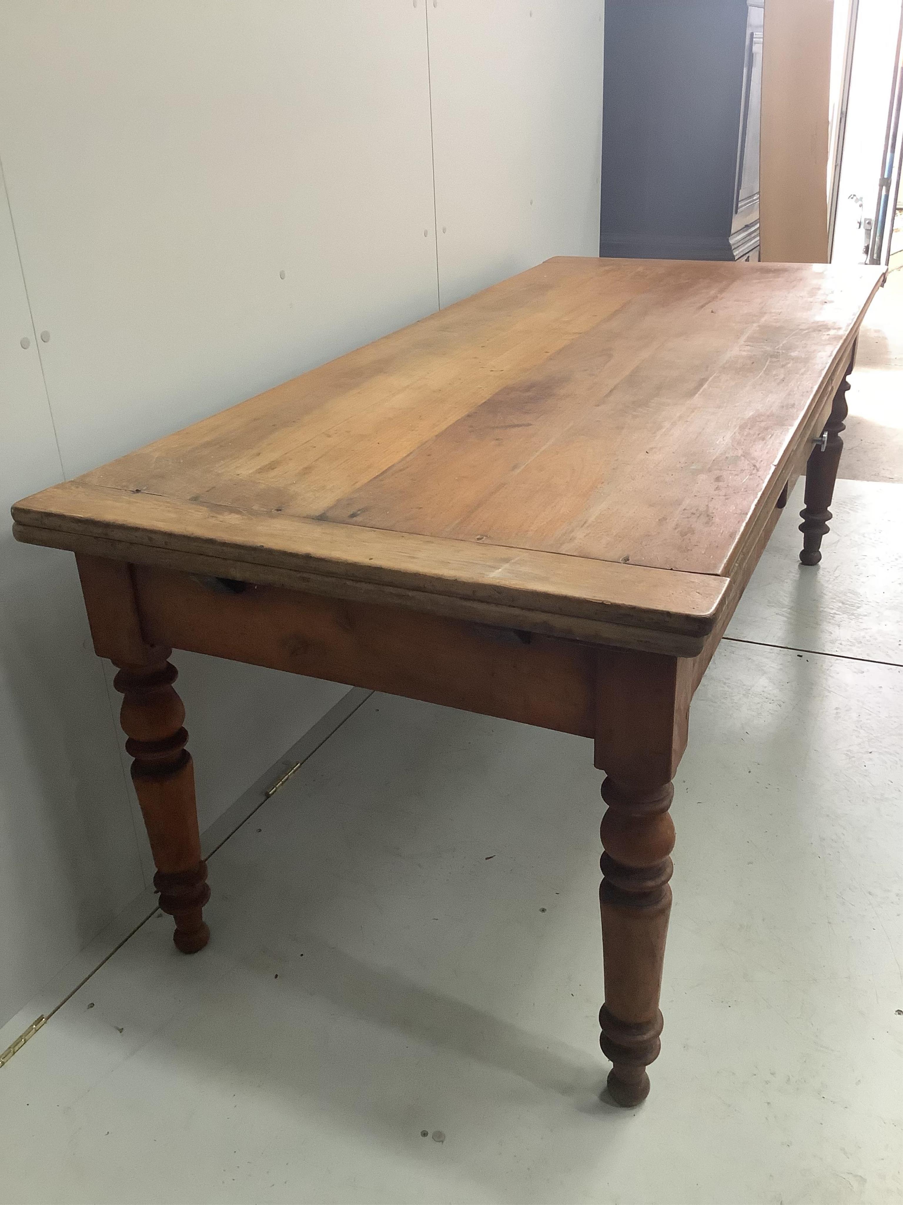 A 19th century French draw leaf kitchen table, width 200cm, depth 84cm, height 76cm. Condition - fair